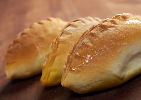 pierogi .Home cake with jam against the wooden table