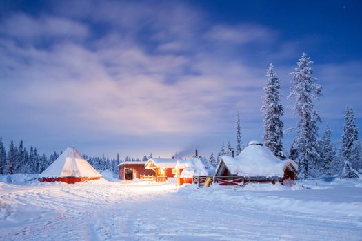 Winter landscape with cabin hut at night in Kiruna Sweden lapland at Night with star trail