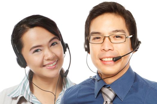 A smiling man and woman wearing headsets