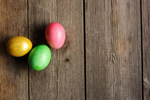 Colored easter eggs on wooden table