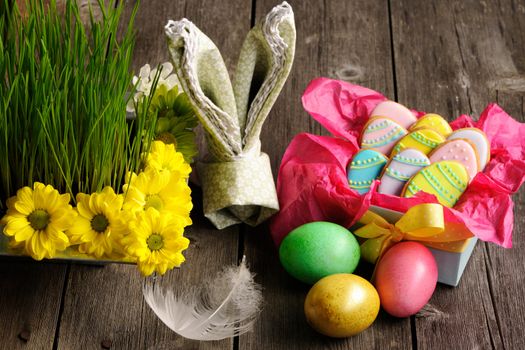 Easter homemade gingerbread cookie and eggs over wooden table