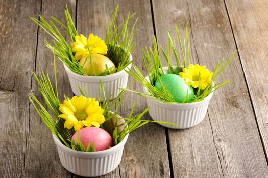 Colored easter eggs on wooden table