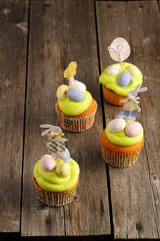 Easter homemade cupcakes over wooden table