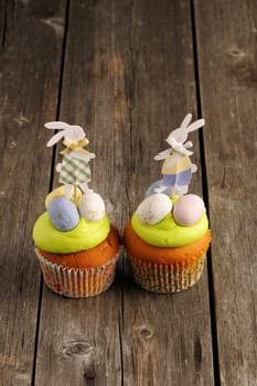 Easter homemade cupcakes over wooden table