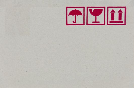 Safety fragile icon on cardboard paper box with space