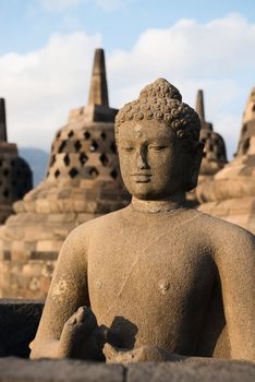 Buddha statue and stupas in Borobudur, or Barabudur, temple Jogjakarta, Java, Indonesia. It is a 9th-century Mahayana temple and the biggest  Buddhist Temple in Indonesia.