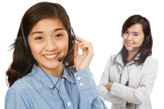 Two young women wearing headsets (on white background)
