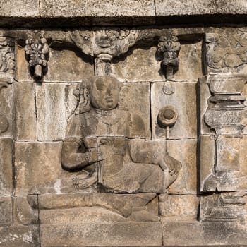 Detail of Buddhist carved relief at Borobudur temple on Java, Indonesia