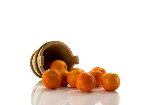 tangarines and wooden bucket, isolated on white