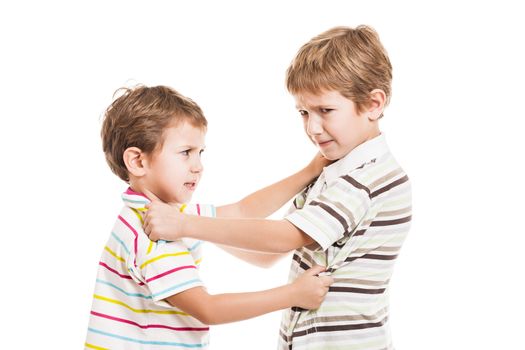 Two little displeased child boy brothers fighting in family conflict