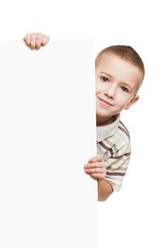 Little smiling child boy holding blank white sign or placard