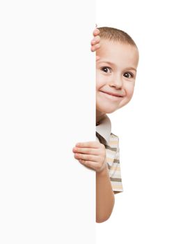 Little smiling child boy holding blank white sign or placard