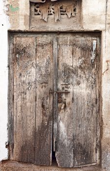 Old dilapidated wooden door. Rajasthan, India