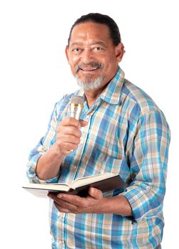 A senior preacher with a microphone and book appears as happy as can be.