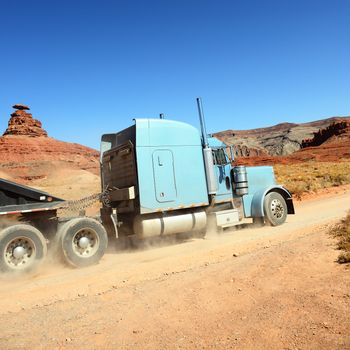 Semi-truck driving across the desert, USA