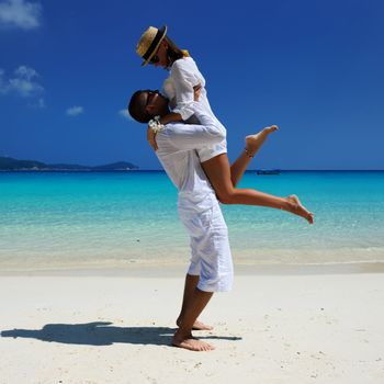 Couple in white on a tropical beach