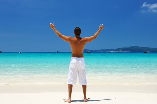 Man in white at tropical beach