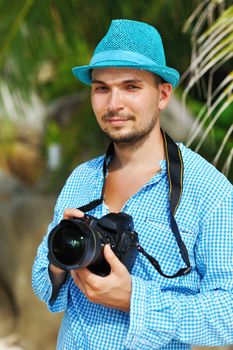 Man on a beach with camera