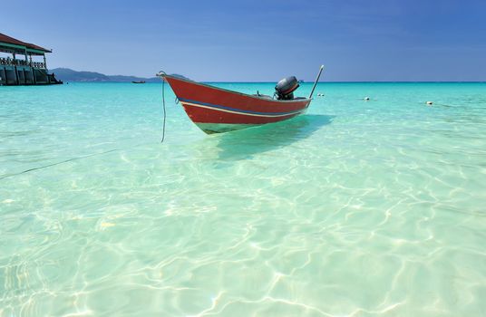 Beautiful beach with motor boat at Perhentian islands, Malaysia