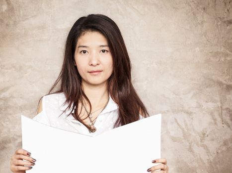 young woman reading book or magazine