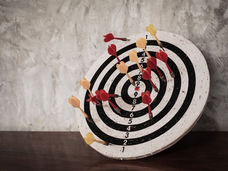 Success concept, darts hit target on dartboard