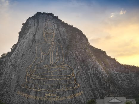 Buddha image carved with laser at the mountain, Thailand