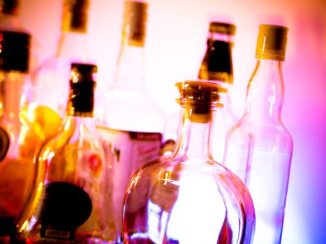 Various bottles at a bar arranged in rows