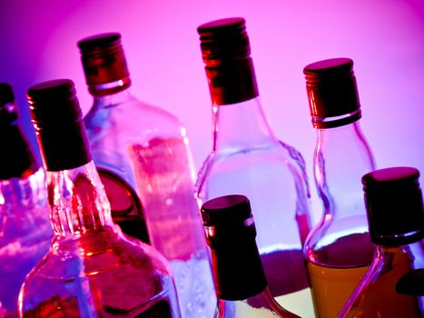 Various bottles at a bar arranged in rows