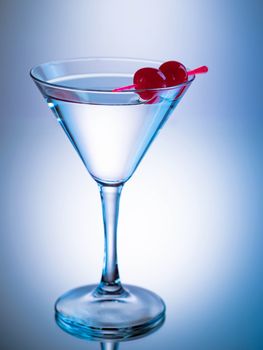 Cocktail in a martini glass with maraschino cherries