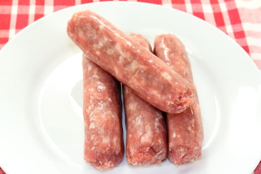 raw fried sausage on a white plate