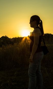 Woman silhouette in a sunset  pin field