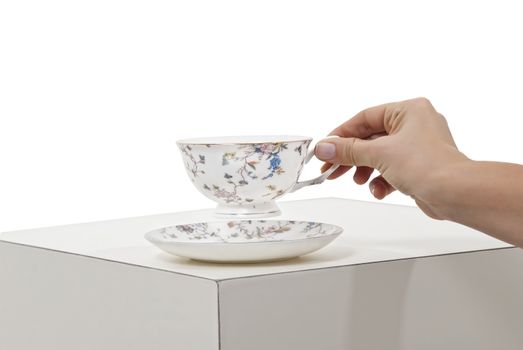 a cup in a hand is isolated on a white background