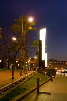 Nightview of Nervión river promenade and the original lamppost, in Bilbao, Spain