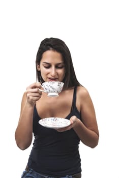 Lovely young woman with a cup of coffee in hands isolated on white background 