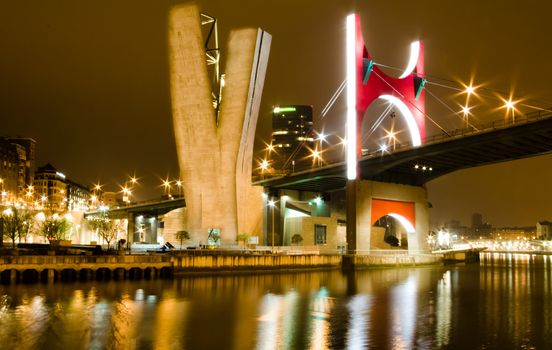 Nightview of Princes of Spain bridge, better known as La Salve bridge, over tne Nervión river in Bilbao, Spain. The commemorative red arc was designed by french artist Daniel Buren in 2007