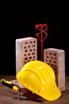 Bricks, trowel and helmet on work place 