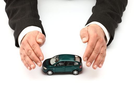 Hands and car model.  Insurance concept 
