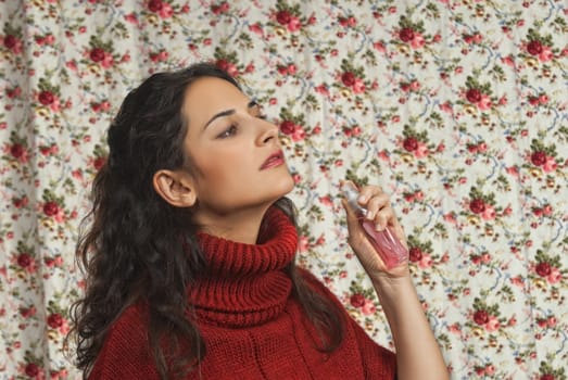 Woman with parfume with colorful floral background