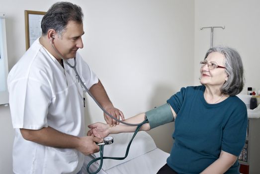 Doctor measuring mature patient blood presure