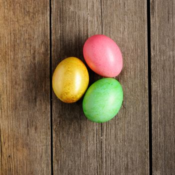 Colored easter eggs on wooden table