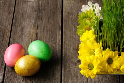 Colored easter eggs on wooden table