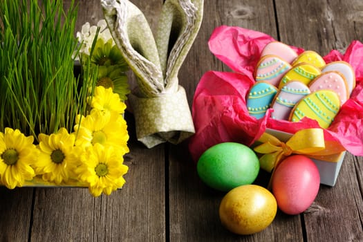 Easter homemade gingerbread cookie and eggs over wooden table