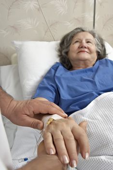 Adult helping senior in hospital