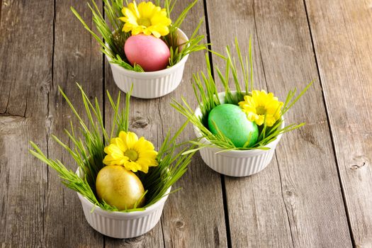 Colored easter eggs on wooden table