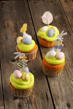 Easter homemade cupcakes over wooden table