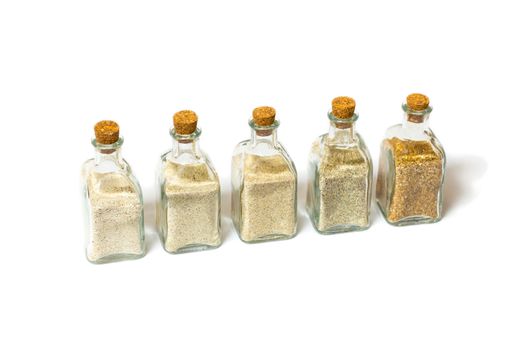 Beach sands varieties collection in five small glass bottles