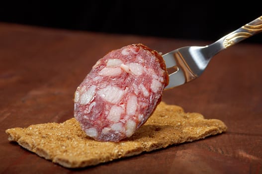 Salami and bread. close up with washed away by back background