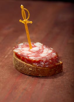 Canape with salami . Shallow depth-of-field. 