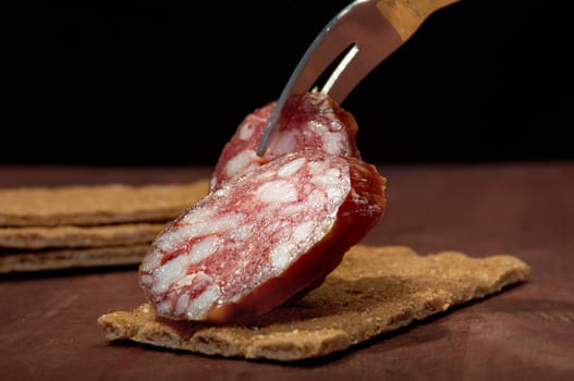 Salami and bread. close up with washed away by back background