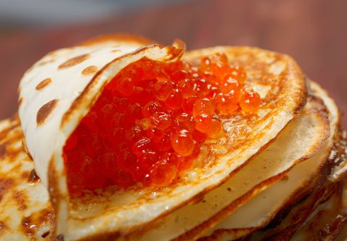 Traditional Russian pancakes  with red caviar